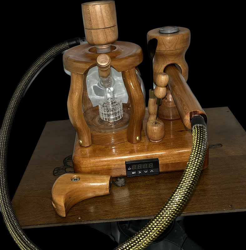 Made in a small family shop in the Southeast United States, each system is unique. This is a true conversation piece of functional art! Each set may contain different parts and of course will offer an individual mixture of woods and beauty only nature can provide.
This particular set includes:
24” whip and 12” wooden mouthpiece with Integrated Orb V2 Bracket System
Integrated PID Controller with US Standard Five Pin XLR Connection w/included Injector Stand
19mm Male Handmade Bowl with Glass Filter