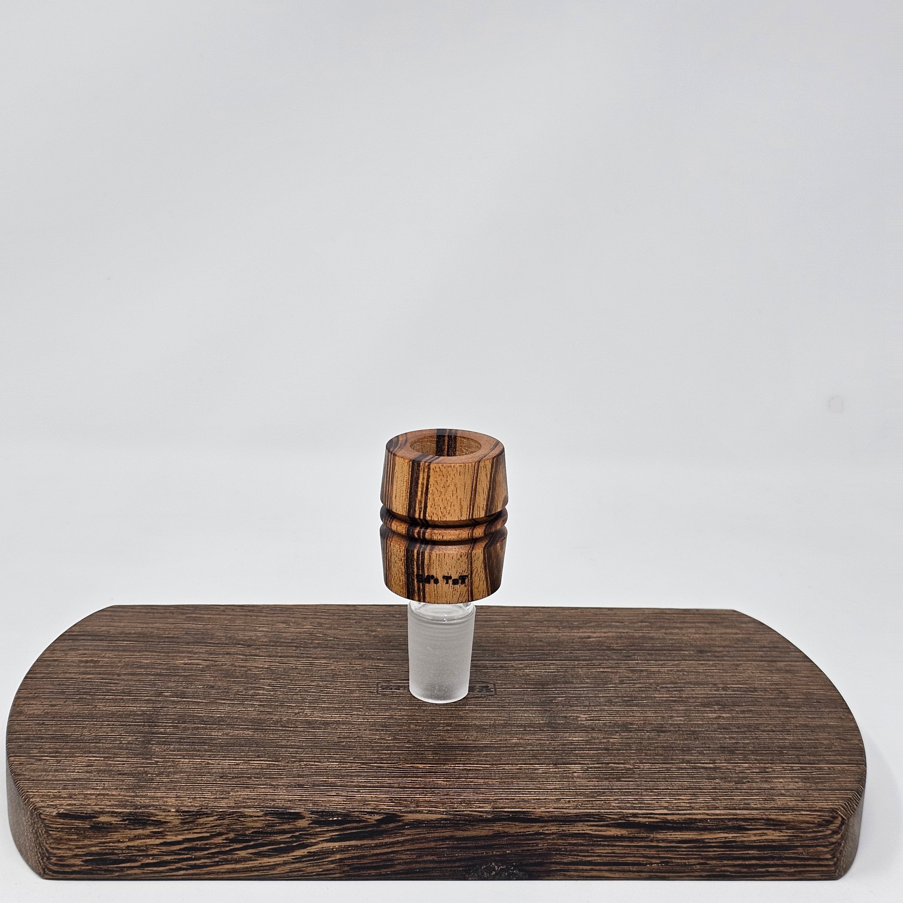 Hand made in Mississippi from Tigerwood. Tigerwood has a lot of color and grain variance so it may differ significantly from the picture.
Glass stand and CT8 not included in purchase just shown for demonstration.
Has a hands free fit with Ruby twist and a looser but airtight seal with CT8.