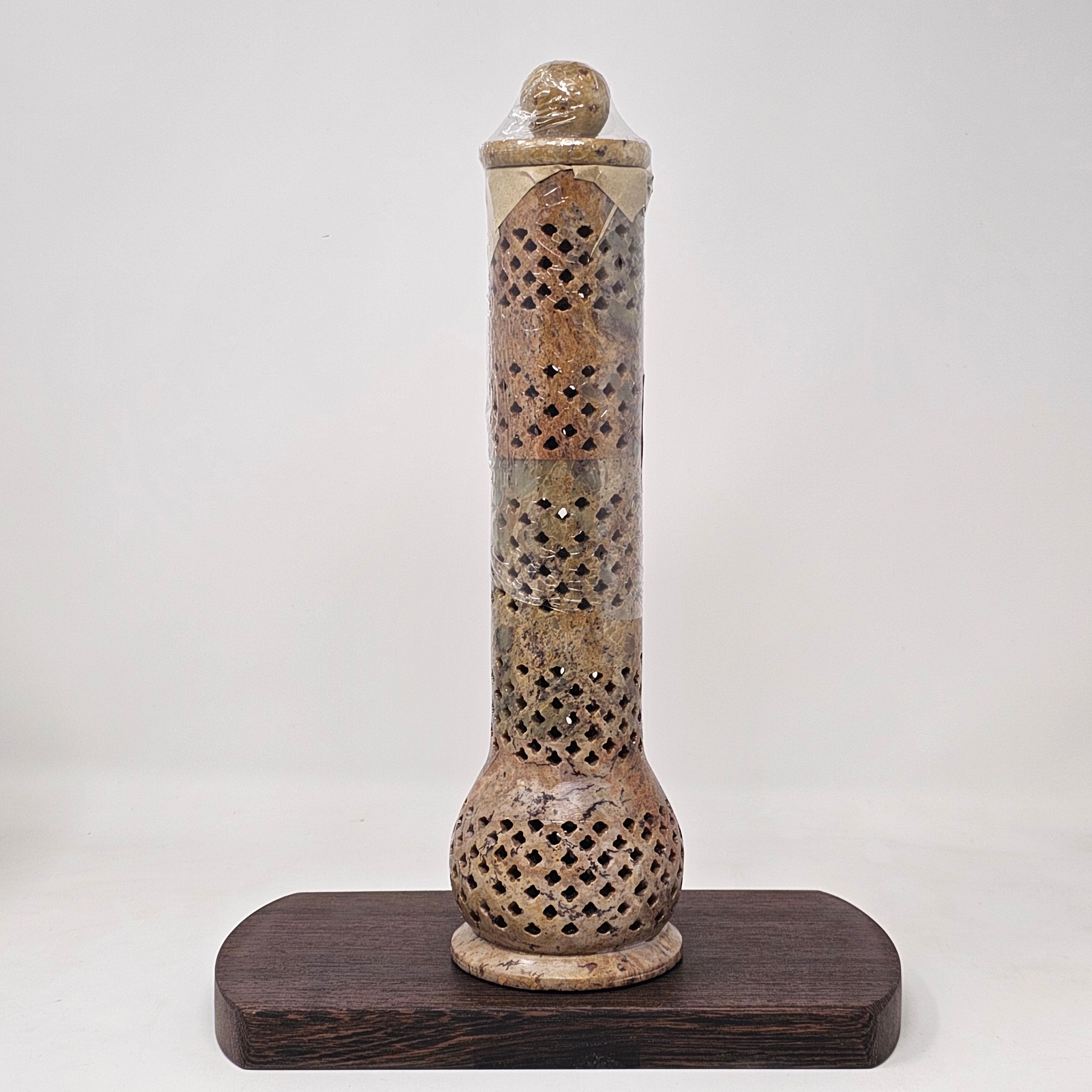 A beige soapstone incense burner with geometric cut-outs and patterns