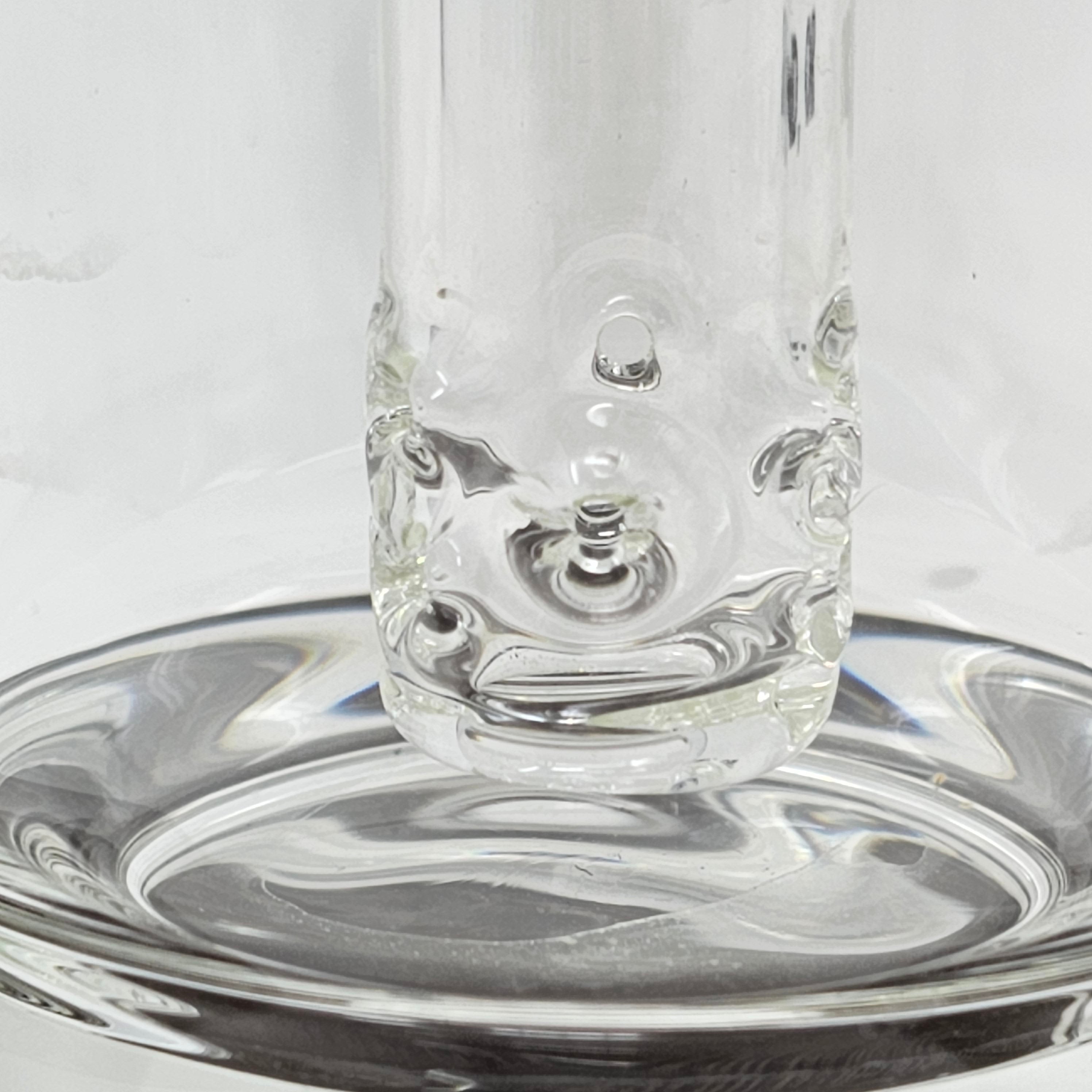This bubbler is made on 65mm heavy walled tubing and comes with a jumbo in-house diffused 9-hole double ground bushing down stem (18mm female). Mouthpiece is removable and fits on a 19 mm fitting. Down stem is also removable for easier cleaning.
Height of body 11-12" with mouth piece 17-18". Made in the USA!!!
** This product is individually handmade by the same or different glass blower and there may be a variation in size of product. There could also be a variation in the logo size, placement, and col…