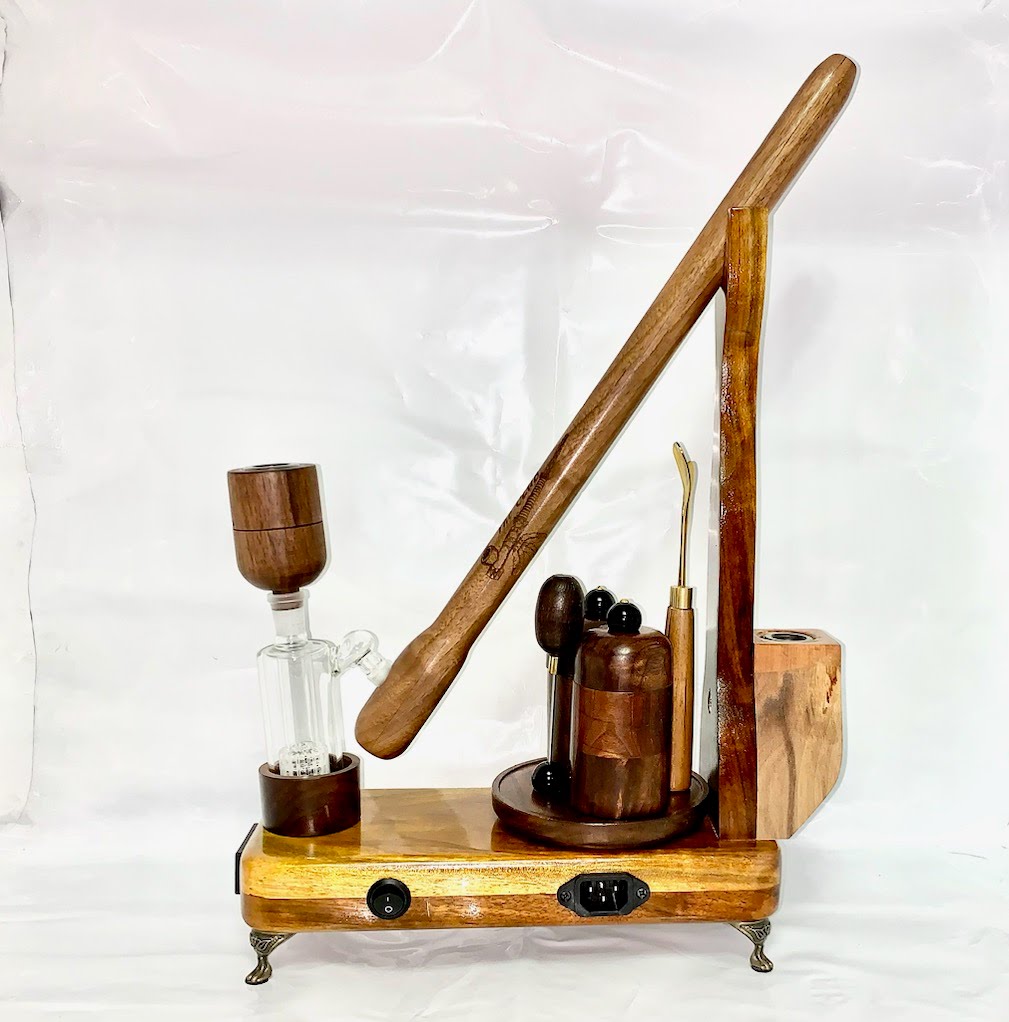 Made in a small family shop in the Southeast United States, each system is unique. This is a true conversation piece of functional art! The Club is 24 inches long and includes carb hole. Each set may contain different parts and of course will offer an individual mixture of woods and beauty only nature can provide.
This particular V1 set includes:
18” Club Pipe ( 1/4” bore) with integrated ash catcher filter system.
Integrated PID Controller with US Standard Five Pin XLR Connection w/included Injector…