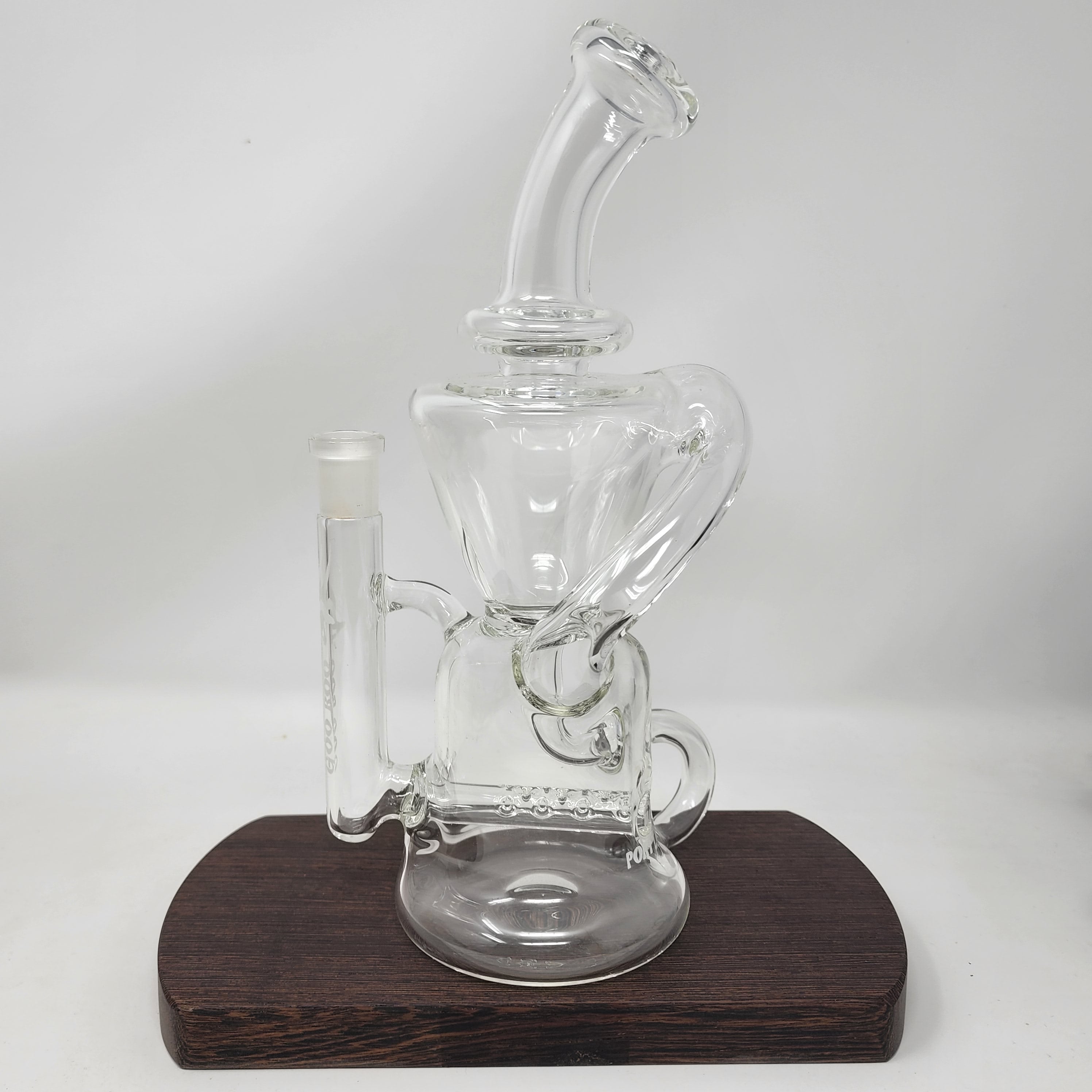 A Goo Roo Glass flagship rig, the Klein recycler has incredible function and appearance. Fitting is 14mm Female. Made in USA!
** This product is individually handmade by the same or different glass blower and there may be a variation in size of product. There could also be a variation in the logo size, placement, and color…