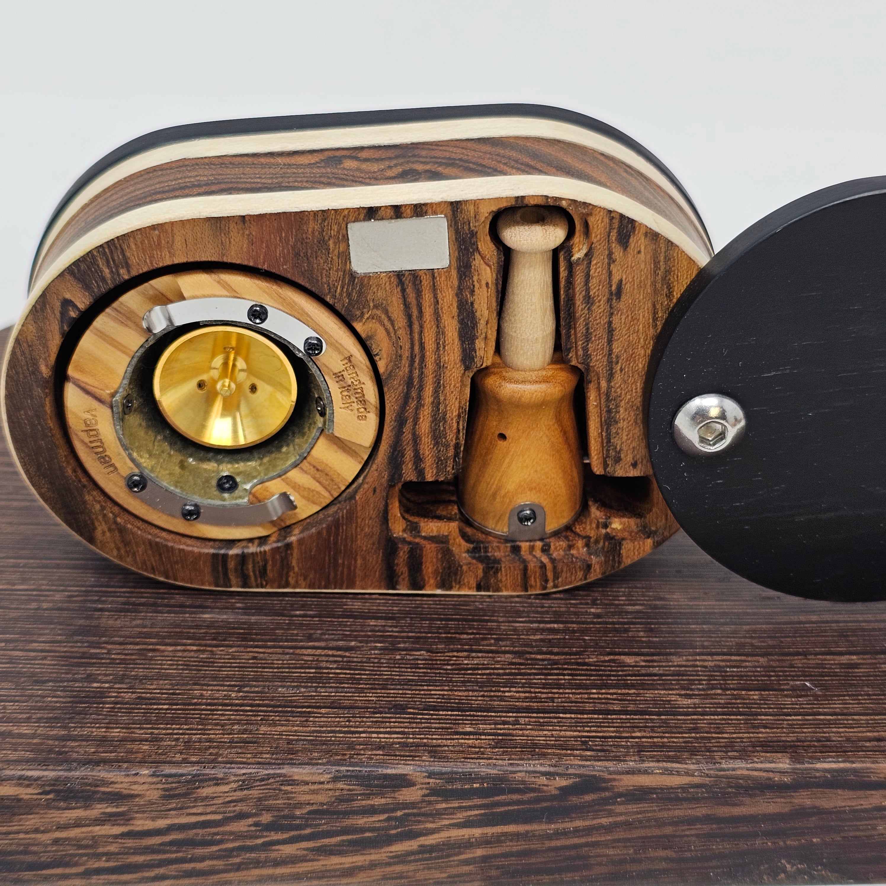 Vapman Case in Bocote/Sycamore/Ebony.

Handcrafted in the United Kingdom by PhattPiggie.

You are purchasing one Vapman case. No Vapman unit is included. One is shown for demonstration purposes only. Case operates with a rotating magnetic lid.