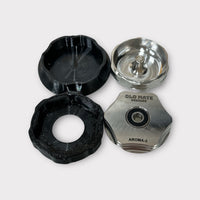 Grippy Boys next to the top and bottom sections of the Aroma 3 Grinder