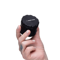 Black 2.5" 4-Piece Assembled Grinder in Hand View for Size Reference