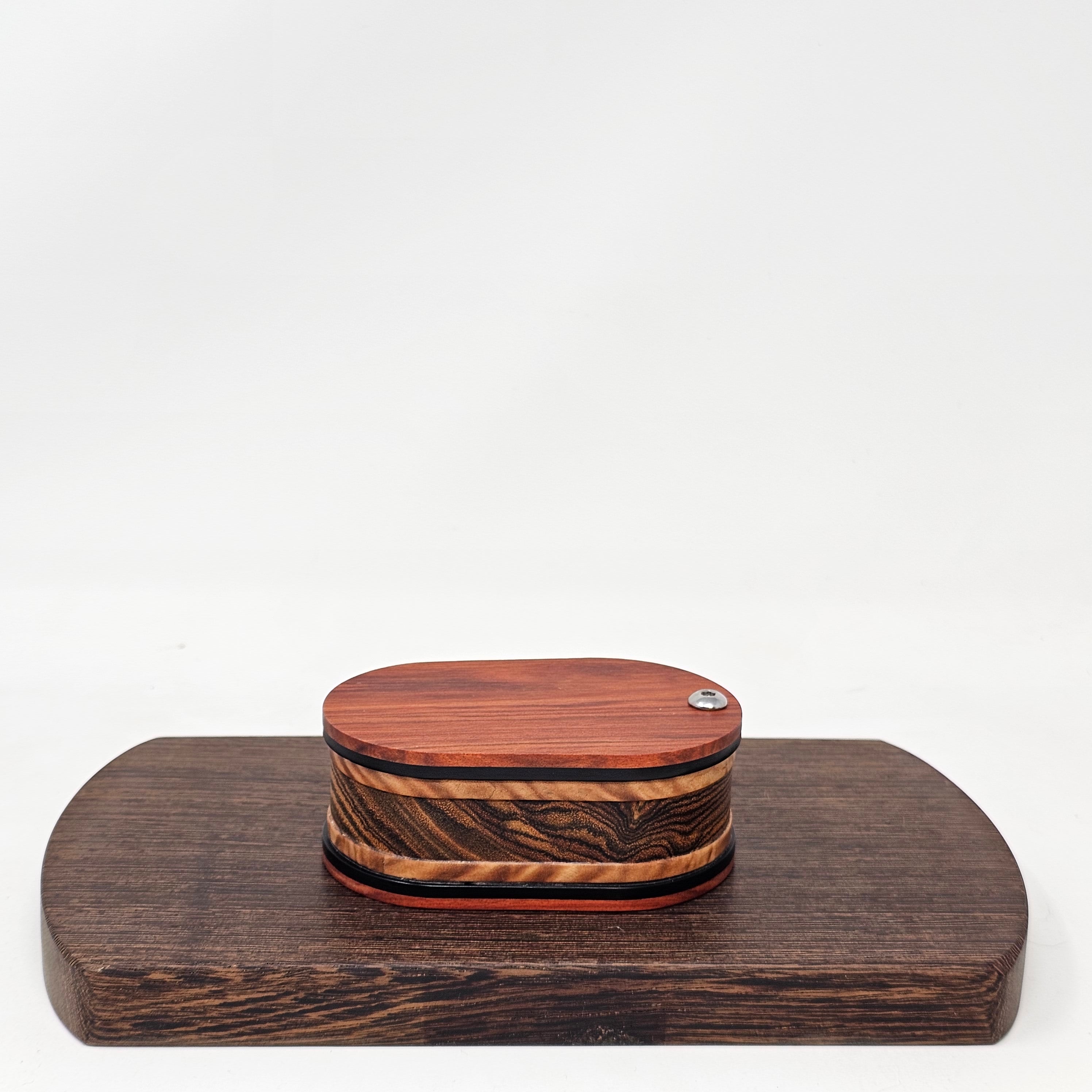 Vapman Case in Redheart/Acrylic/Maple Burl/Bocote.

Handcrafted in the United Kingdom by PhattPiggie.

You are purchasing one Vapman case. No Vapman unit is included. One is shown for demonstration purposes only. Case operates with a rotating magnetic lid.