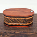 Vapman Case in Redheart/Acrylic/Maple Burl/Bocote.

Handcrafted in the United Kingdom by PhattPiggie.

You are purchasing one Vapman case. No Vapman unit is included. One is shown for demonstration purposes only. Case operates with a rotating magnetic lid.