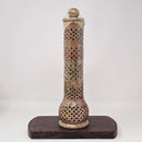 A beige soapstone incense burner with geometric cut-outs and patterns