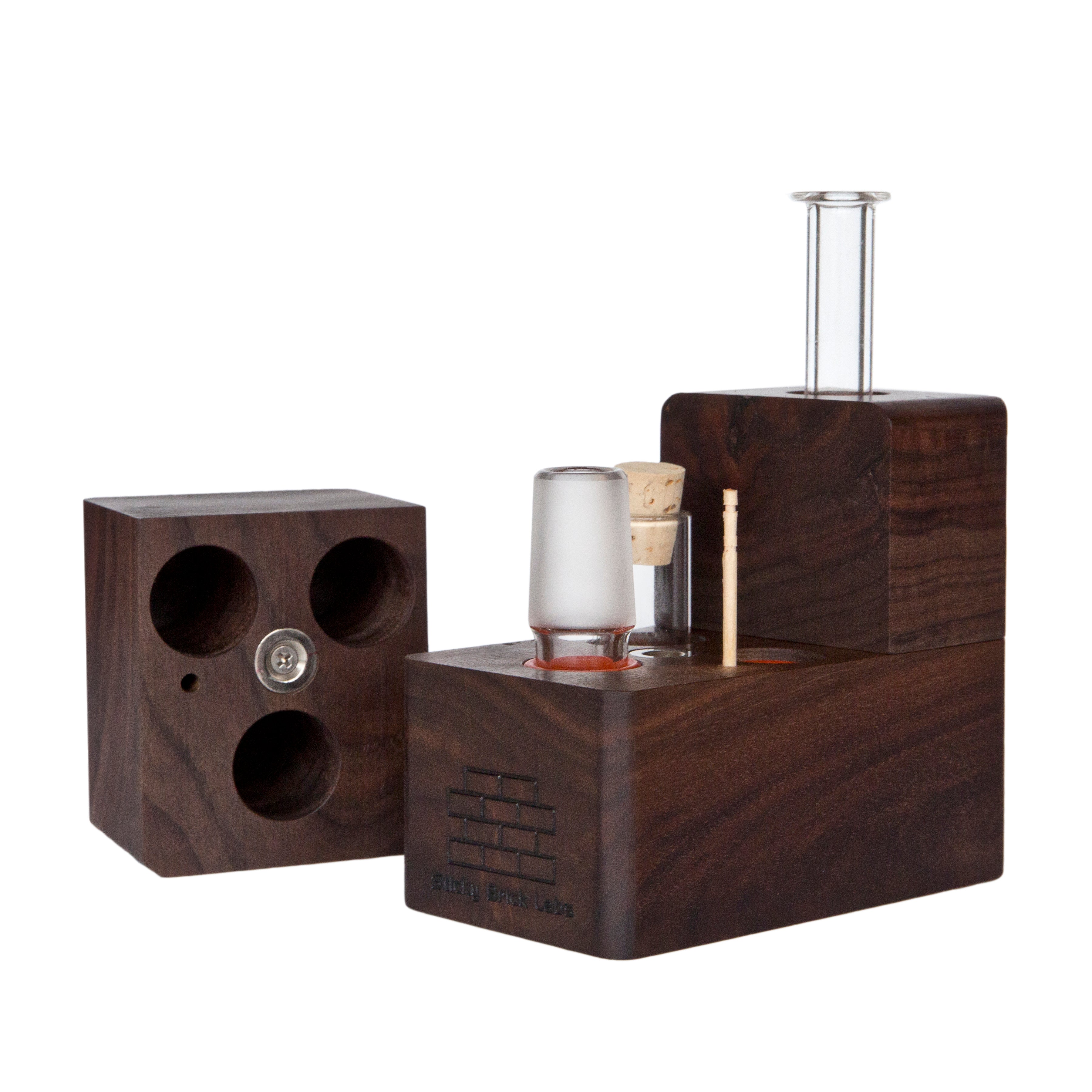 The Sticky Brick Maxx is available in a variety of wood choices. Ships with a torch, 18mm female, 18mm male, and 14mm male whip connectors along with 16” of silicone whip tubing, 18mm female dry mouthpiece, 6-pack of screens, carb corks, an extra jar cork, and led tweezers. Now ships with two Restrictor Discs.